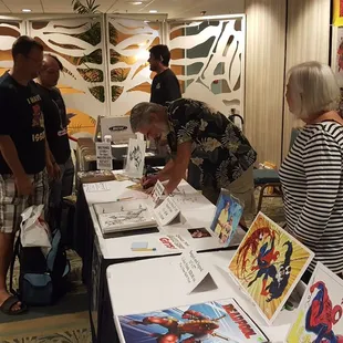 Comic book artist Randy Emberlin signing prints.