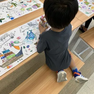 Son Son coloring while waiting for class.