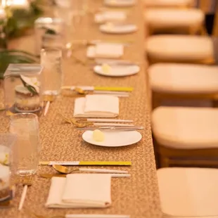 Wedding party head table with elegant gold &amp; white Jacqueline flatware.