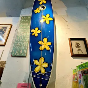 a blue surfboard with yellow flowers