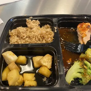 Half eaten Spicy Hawaiian Salmon with Fried Rice Entrée