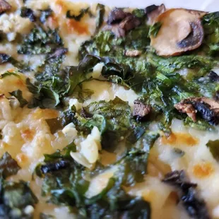Close-up, Spinach, Mushroom and Garlic. (Cut halves of an individual slice, one normal slice is two of these slices combined).