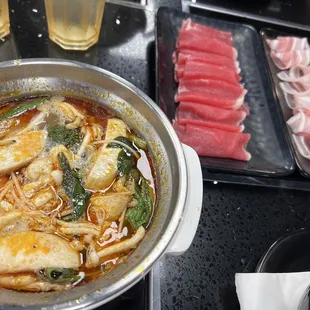 Tom yum broth, ribeye, and pork belly