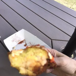 a person holding a half eaten sandwich