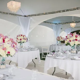 Crystal Faux Beaded Chandeliers, White Linen Leg Drapes, and Tivioli Style Lighting