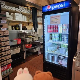 Entrance to kitchen next to refrigerated drinks
