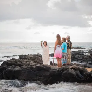 Kahu Pomaika`i chants at the oceans edge before the wedding ceremony.