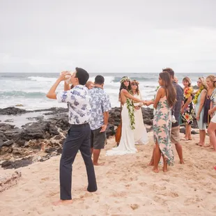 Po`okela with Hawaiian Aloha Blessings blows the pu to summon the couples ancestors for the wedding ceremony.