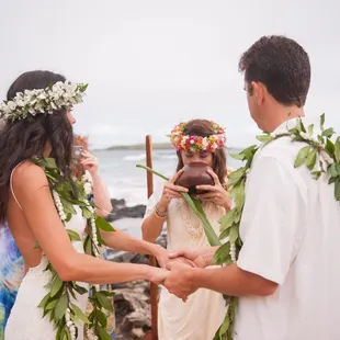 Breathing her &quot;ha&quot;, Kahu Pomaika`i blesses the wedding rings.