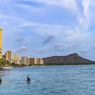 Surfers paddling in from a surf spot called &quot;tongs&quot; a little down the ways from the more popular Waikiki surf breaks