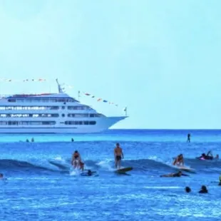 Surfers sharing the waves! &quot;Party wave&quot; as us locals would call it. Local cruise line photo bombing