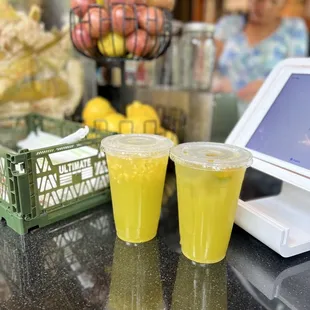 two glasses of juice on a counter