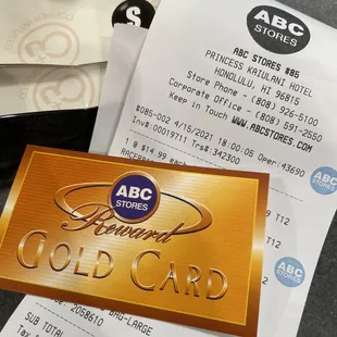 a gold card and a pair of scissors
