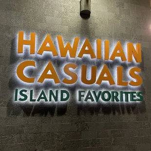a neon sign on a brick wall