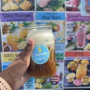 Cold brew vegan cold foam iced coffee in front of their menu