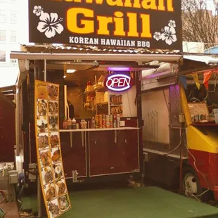 a food stand with a neon sign