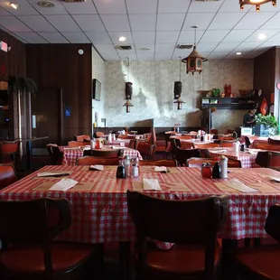 a dining room with red and white checkered tablecloths