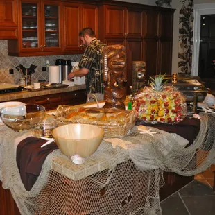 Hawaiian Luau of OC setting up the luau feast in a private home