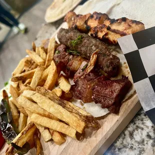 a steak and fries on a cutting board