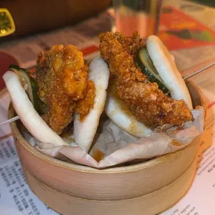 Seoul Hot Chicken Baos    24-hour brined chicken thigh, deep-fried and sauced in garlic gochujang. Topped with a spicy house-made pickle.