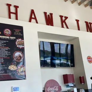 Interior with menu and one of their two televisions.