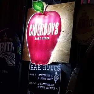 a neon sign with a red apple on it