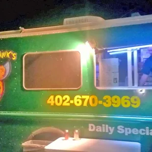 a green food truck at night
