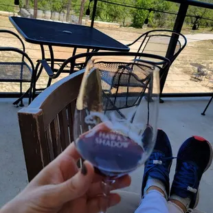 a person holding a glass of wine