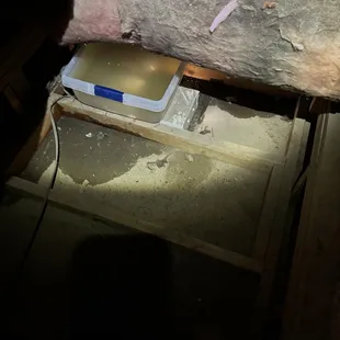 Water leak caught in plastic bin.