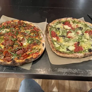 two pizzas on a table