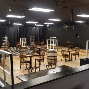 Distanced indoor seating, with glass panes separating tables.