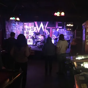 people playing a game of pinball