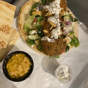 Super falafel with side of humus with olive oil and pita bread taziki sauce and hot sauce so yummy