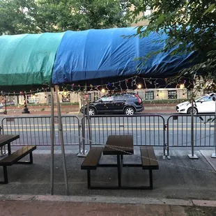 a blue tarp covering a table and benches
