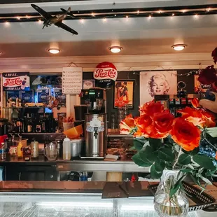 a vase of flowers in front of the counter