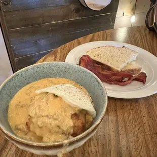 Biscuits and gravy with sides of bacon and sourdough