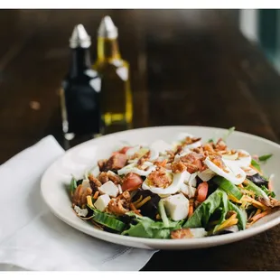 Chef Salad mixed greens, Ovengold® Turkey, Bacon, cheddar, tomato, cucumber, carrots, egg, choice of dressing