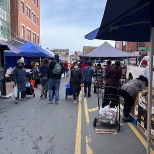 people shopping at a farmers market