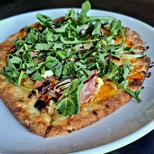 Flat bread with prosciutto, goat cheese, fig  jam, and arugula