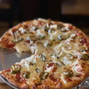 a whole pizza on a serving tray
