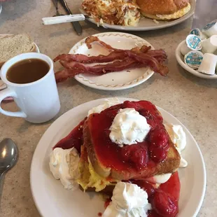 (From front to back) Stuffed French Toast, side of bacon, Breakfast Croissant