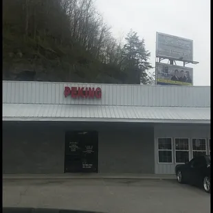 a photo of a car parked in front of a building
