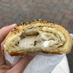 Snapshot of middle of the everything croissant with chive cream cheese in middle