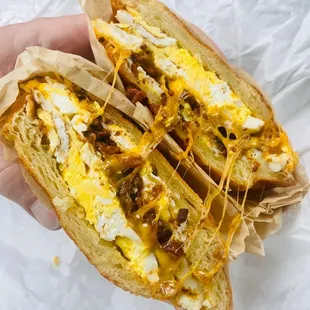 Bacon egg and cheese sandwich (extra egg) on a croissant roll