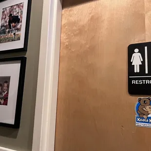 a bathroom with a toilet and a picture frame
