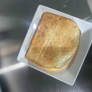 a piece of toast on a square plate