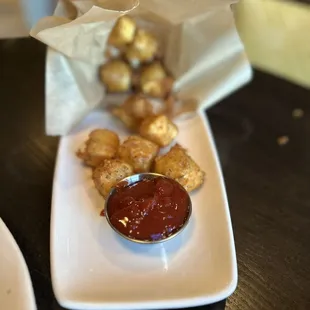 a plate of tater tots with ketchup
