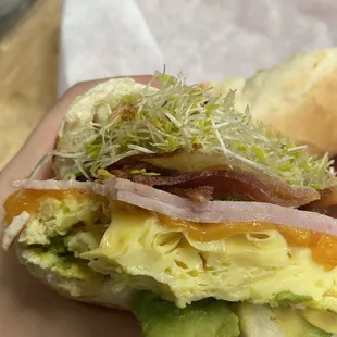 egg, ham, bacon, cheese, sprouts, and avocado