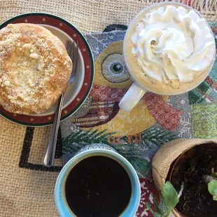 two cups of coffee and a pastry