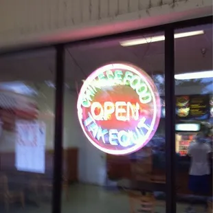 a neon sign in the window